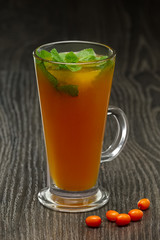Glass of hot fruit tea on wooden table