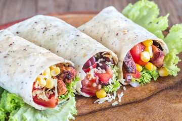 Three chicken burritos