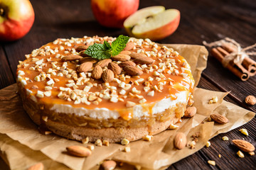 Apple cake with whipped cream, caramel and almond topping