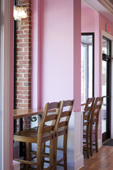 Pink and white bakery interior with exposed brick