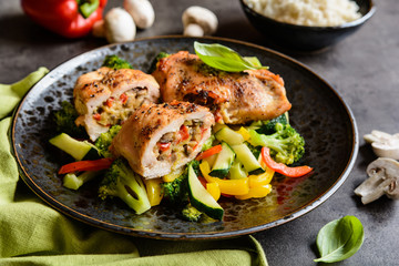 Roasted chicken breasts stuffed with vegetable and sheep cheese, served with steamed vegetable and rice