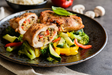 Roasted chicken breasts stuffed with vegetable and sheep cheese, served with steamed vegetable and rice