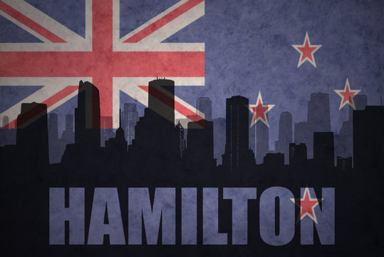 abstract silhouette of the city with text Hamilton at the vintage new zealand flag