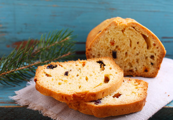 homemade cake with raisins and nuts cut into pieces on a blue background