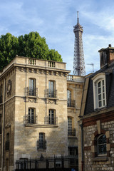 Fototapeta na wymiar The Eiffel Tower seen behind buildings in Paris, France