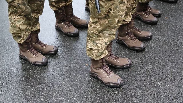Feet of soldiers. Soldiers in military uniform. Servicemen at the military parade
