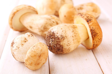 White mushrooms on a white wooden background