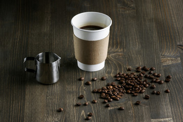 Coffee drink in a white cup, on a wooden background