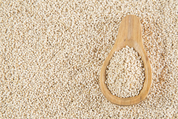 Quinoa seeds on wooden spoon