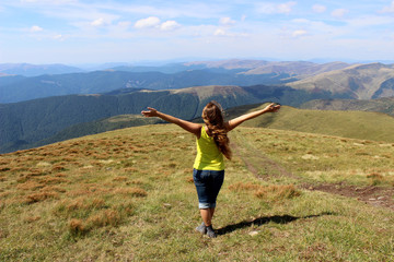 The girl tourist (young woman) with long hair looks at the mount