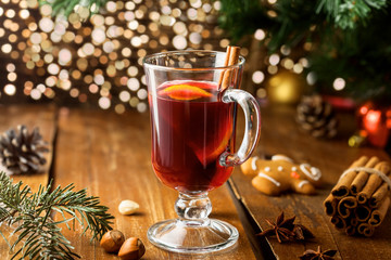 Mulled wine for Christmas Eve celebration party by Christmas tree. Hot traditional winter drink for New Year eve.
