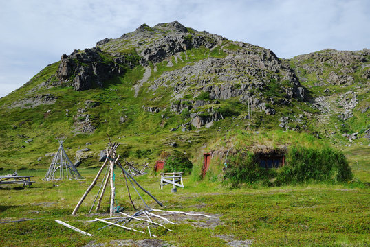 Summer view of Mageroya with Sami frames and mossy huts.