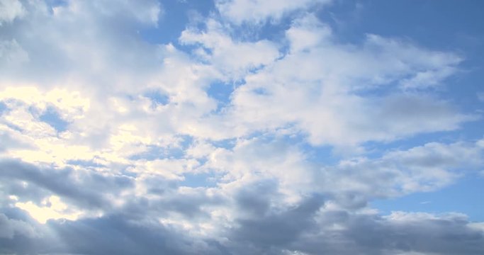 clouds timelapse and sunrise breaking through cloud mass.