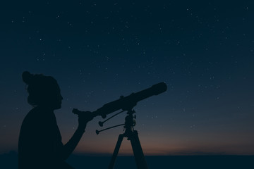 Naklejka premium Woman with astronomical telescope. Starry night Constellations, Ursa major, Leo minor, Leo, Draco Botes, Canes Venatici, Coma Berenices