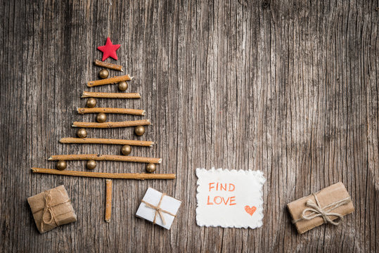 Xmas tree and gift box on rustic wooden background