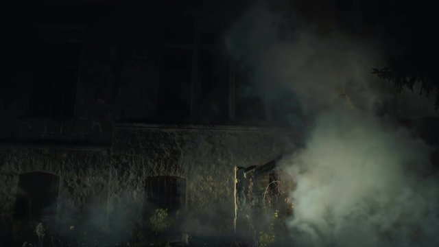Scary ghost of the dead bride on background old medieval house