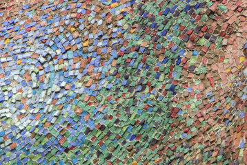 Fototapeta na wymiar Wall decorated with mosaic tiles and colored bricks Photo execut