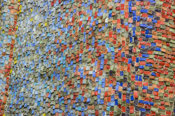 Wall decorated with mosaic tiles and colored bricks Photo execut