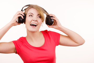 Naklejka premium Woman in big headphones listening music isolated