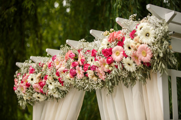 Wedding decor. Decorations of fresh flowers on the wedding arch