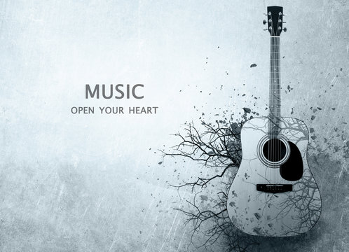 Acoustic guitar with leafless tree branches on gray background. Text MUSIC OPEN YOUR HEART. Creative art work concept.
