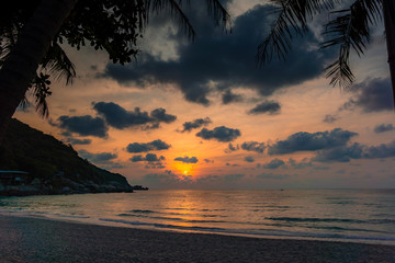 Obraz na płótnie Canvas Sunrise over full moon party beach in Thailand
