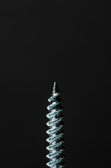 Image of a screw on black background