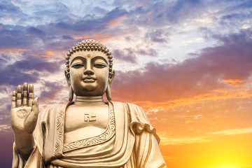 Big Buddha statue on sunset sky