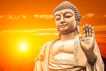 Big Buddha statue on sunset sky