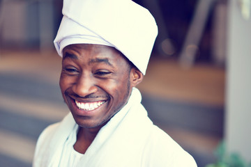 Sudanese business man in traditional outfit using mobile phone in office
