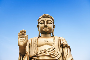 Buddha statue on the blue sky