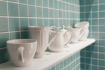 Clean cups on wooden shelf