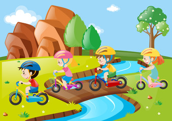 Children riding bicycle over the bridge