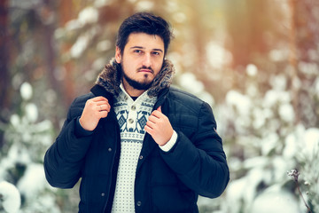 portrait of young handsome bearded men in the woods in the winte
