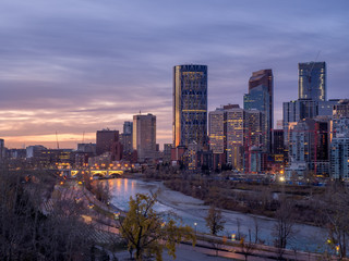 Calgary's skyline at sunrise along the Bow River.