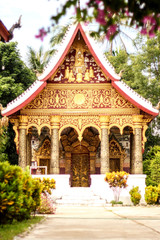 Fototapeta na wymiar Golden Laos style temple building landmark in Laos
