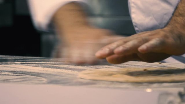 Male chef makes pizza cake