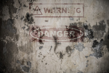 Faded danger sign on the wall