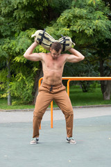 Man Performing Bag Squat Exercise Outdoor
