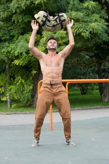 Man Performing Bag Squat Exercise Outdoor