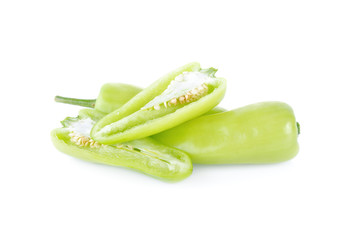 whole and half cut fresh green chili on white background