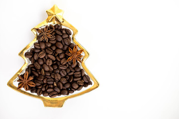 Gold plate in the form of a Christmas tree with coffee and anise