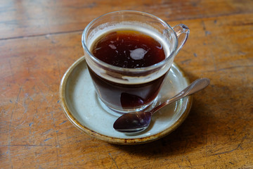Hot americano coffee on wooden table.