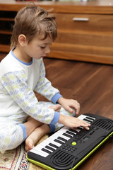 Boy playing on synthesizer