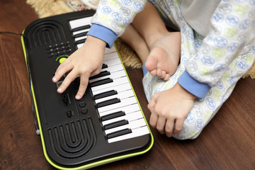 Child playing on synthesizer