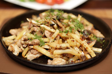 Pan with fried potatoes and meat