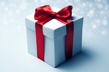 White gift box with red ribbon