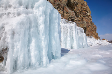 Fototapeta na wymiar Rocks covered by ice on winter siberian Baikail lake
