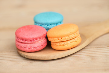 macaron cakes or macaroon on wood background, sweet and colorful dessert, vintage pastel colors tone.