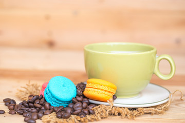 macaron cakes with coffee or macaroon on wood background, sweet and colorful dessert, vintage pastel colors tone.
